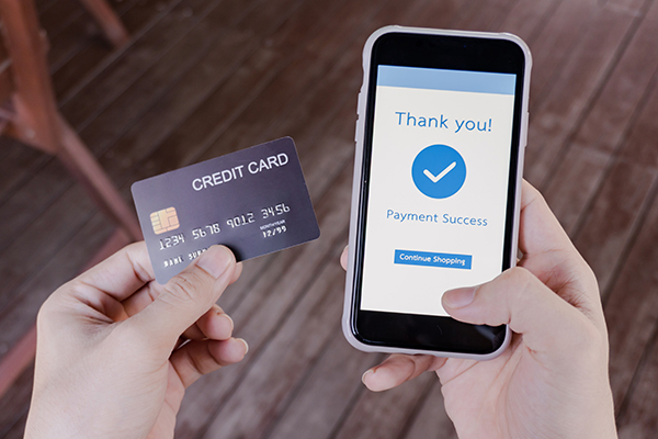 hands holding credit card and phone