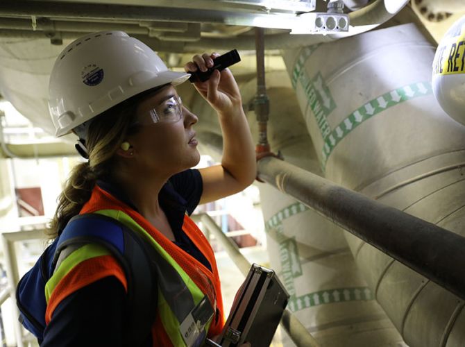 employee checking something in the pipes