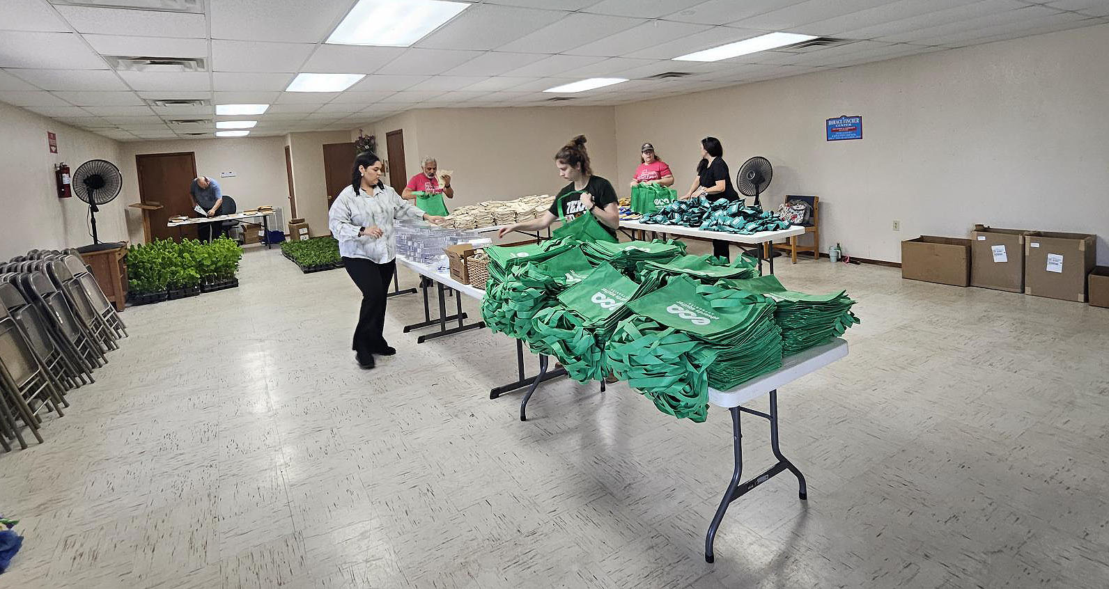 Volunteers setting up the community center for the plan giveaway